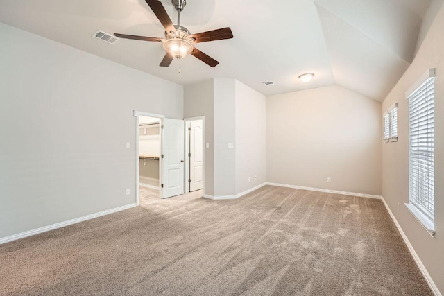 20020 Rhiannon Ln, Pflugerville, TX 78660 - unfurnished bedroom with vaulted ceiling, light colored carpet, a walk in closet, and ceiling fan