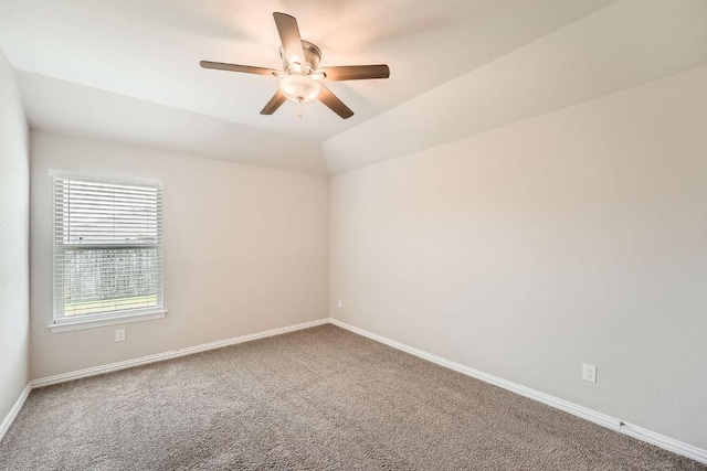 carpeted empty room featuring a ceiling fan and baseboards