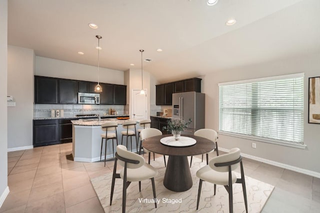 dining room featuring baseboards, recessed lighting, vaulted ceiling, and light tile patterned floors