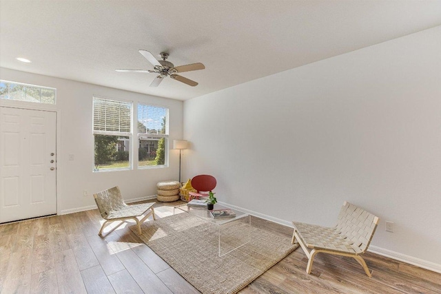 175 Grace St, Kyle, TX 78640 - living area with wood finished floors, baseboards, and a ceiling fan
