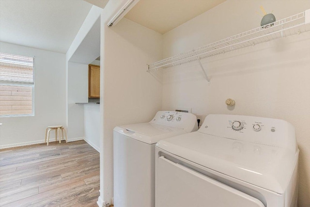 175 Grace St, Kyle, TX 78640 - clothes washing area with washer and dryer, light wood-type flooring, and baseboards