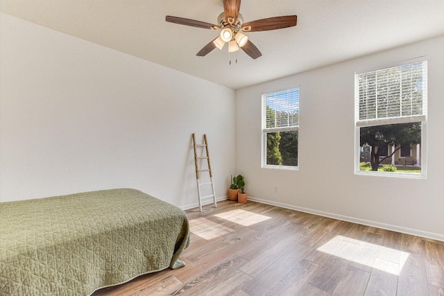 175 Grace St, Kyle, TX 78640 - bedroom featuring wood finished floors, baseboards, and ceiling fan