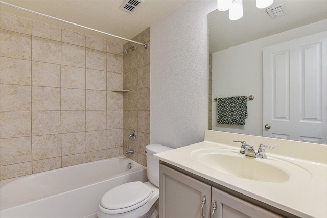 175 Grace St, Kyle, TX 78640 - full bath featuring a textured wall, toilet, vanity, and shower / bath combination