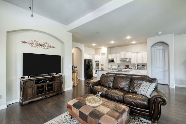 2909 Saint Paul Rivera, Round Rock, TX 78665 - living area with arched walkways, dark wood-style floors, and recessed lighting