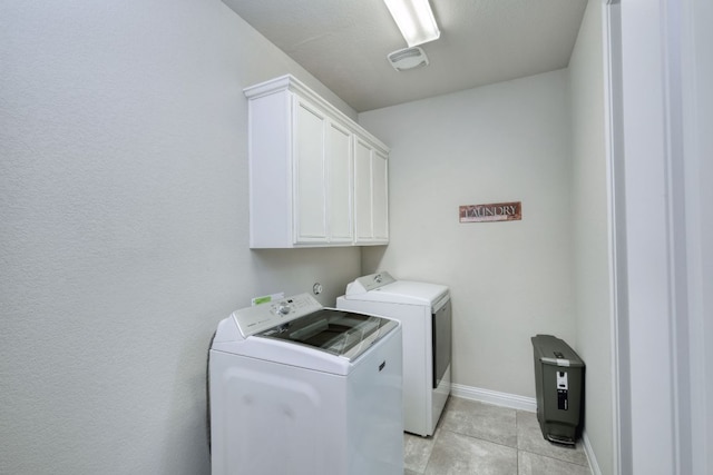 2909 Saint Paul Rivera, Round Rock, TX 78665 - laundry room with washing machine and dryer, cabinet space, and light tile patterned flooring