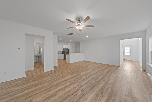 unfurnished living room with ceiling fan, light wood-style floors, baseboards, and recessed lighting