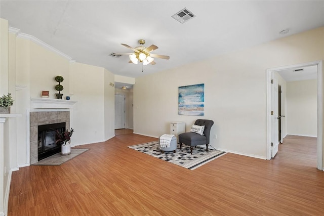 140 Shenandoah Trl, Elgin, TX 78621 - living room featuring a ceiling fan, wood finished floors, baseboards, and a fireplace