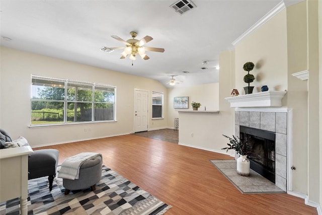 140 Shenandoah Trl, Elgin, TX 78621 - living room with ceiling fan, wood finished floors, a tile fireplace, and baseboards