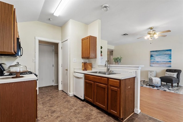 140 Shenandoah Trl, Elgin, TX 78621 - kitchen with white dishwasher, a sink, ceiling fan, brown cabinetry, and lofted ceiling