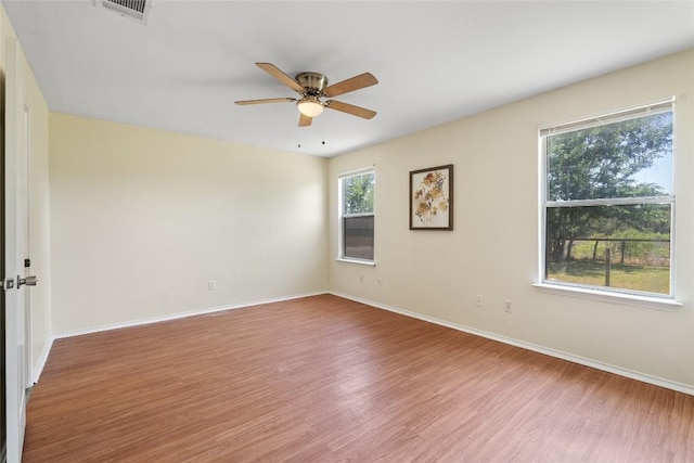140 Shenandoah Trl, Elgin, TX 78621 - spare room featuring wood finished floors, ceiling fan, and baseboards