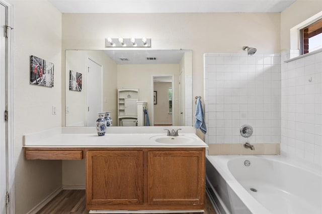140 Shenandoah Trl, Elgin, TX 78621 - bathroom with shower / bathtub combination, vanity, and wood finished floors