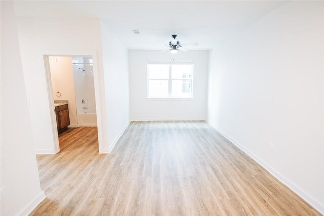 7051 Meadow Lake Blvd Unit 8203, Austin, TX 78744 - unfurnished room featuring light wood-style floors, a ceiling fan, and baseboards
