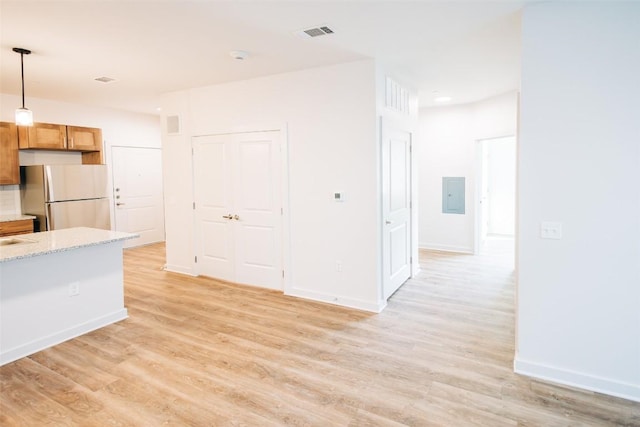 7051 Meadow Lake Blvd Unit 8203, Austin, TX 78744 - kitchen featuring freestanding refrigerator, light wood-style flooring, pendant lighting, and baseboards