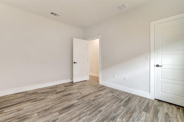 9601 Eloquence Dr, Manor, TX 78653 - unfurnished bedroom with wood finished floors and baseboards