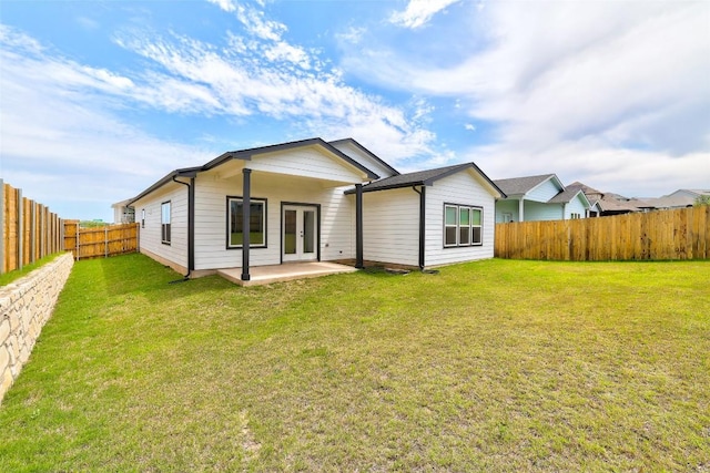 9601 Eloquence Dr, Manor, TX 78653 - rear view of house featuring french doors, a fenced backyard, and a patio