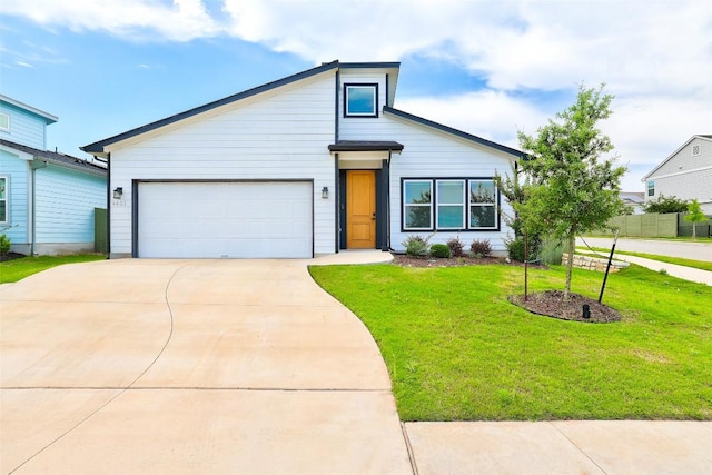 9601 Eloquence Dr, Manor, TX 78653 - view of front of property featuring driveway, a front yard, and an attached garage