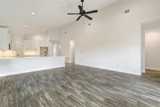 9601 Eloquence Dr, Manor, TX 78653 - unfurnished living room with high vaulted ceiling, a ceiling fan, wood finished floors, and recessed lighting