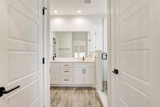 9601 Eloquence Dr, Manor, TX 78653 - full bath featuring a shower stall, double vanity, recessed lighting, and wood finished floors
