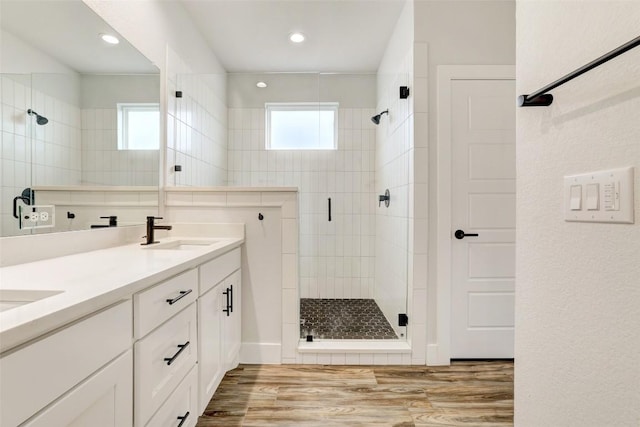 9601 Eloquence Dr, Manor, TX 78653 - full bathroom with a shower stall, wood finished floors, double vanity, and recessed lighting