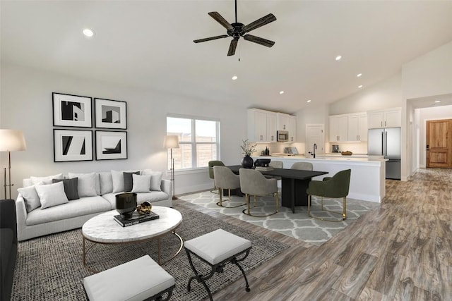 9601 Eloquence Dr, Manor, TX 78653 - living area featuring light wood-type flooring, ceiling fan, recessed lighting, and high vaulted ceiling