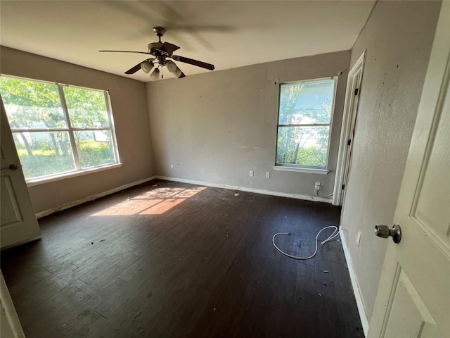 7205 Bethune Ave, Austin, TX 78752 - unfurnished room featuring dark wood finished floors, baseboards, and ceiling fan