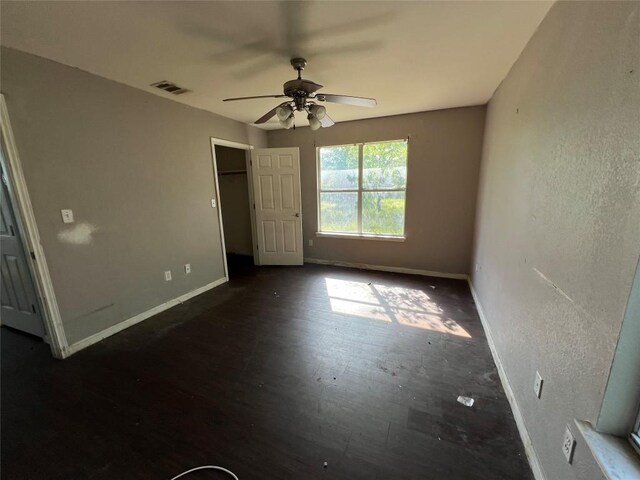 7205 Bethune Ave, Austin, TX 78752 - unfurnished bedroom with baseboards, a spacious closet, a ceiling fan, and a closet