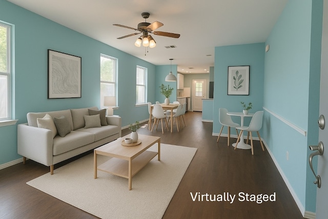 7205 Bethune Ave, Austin, TX 78752 - living area with dark wood finished floors, ceiling fan, and baseboards
