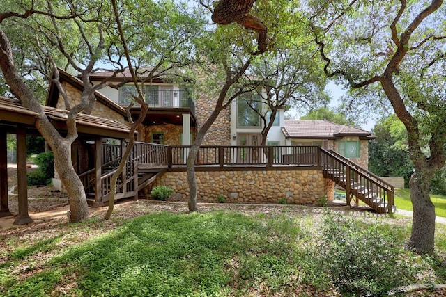 106 Sendera Bonita, Austin, TX 78734 - rear view of house with stairway, stone siding, and a wooden deck