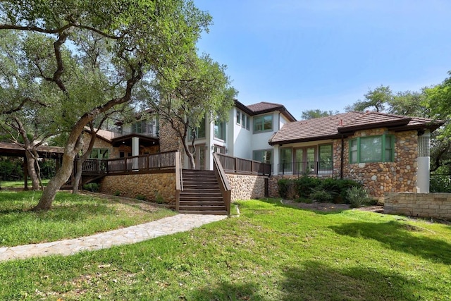 106 Sendera Bonita, Austin, TX 78734 - view of front facade featuring stairs, a front lawn, stone siding, and a tiled roof
