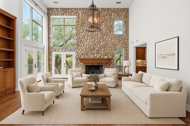 106 Sendera Bonita, Austin, TX 78734 - living room with wood finished floors, a high ceiling, healthy amount of natural light, and a stone fireplace