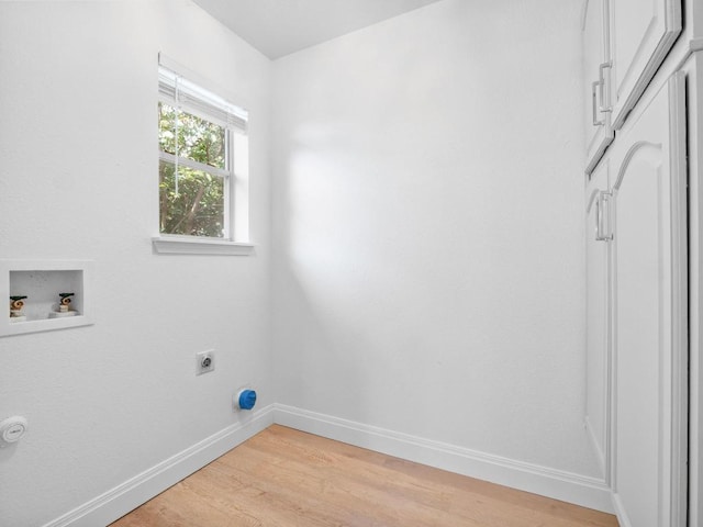 109 Orange Tree Ln, Georgetown, TX 78626 - clothes washing area featuring electric dryer hookup, light wood-style floors, baseboards, and hookup for a washing machine