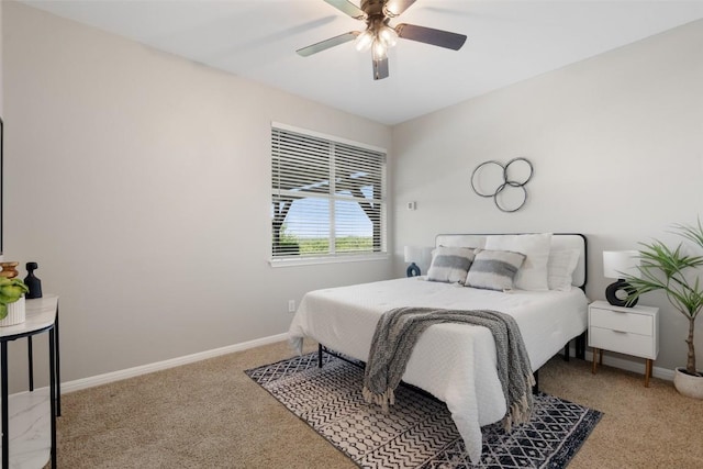 carpeted bedroom featuring baseboards and ceiling fan