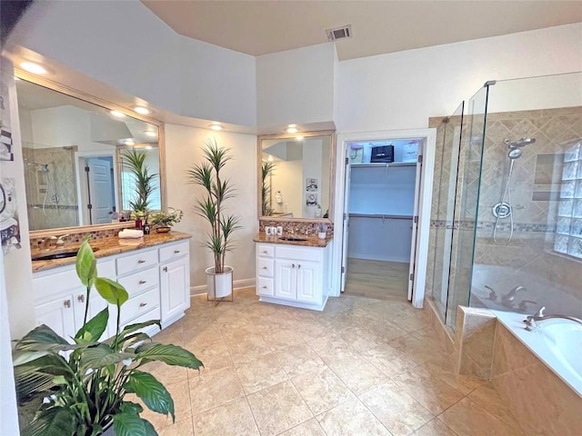 9604 Big View Dr, Austin, TX 78730 - bathroom featuring a shower stall, vanity, a bath, and tile patterned floors