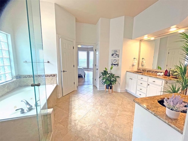 9604 Big View Dr, Austin, TX 78730 - ensuite bathroom with double vanity, a jetted tub, and tile patterned flooring