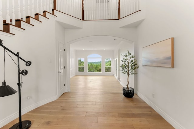9604 Big View Dr, Austin, TX 78730 - entryway with a high ceiling, arched walkways, and light wood finished floors