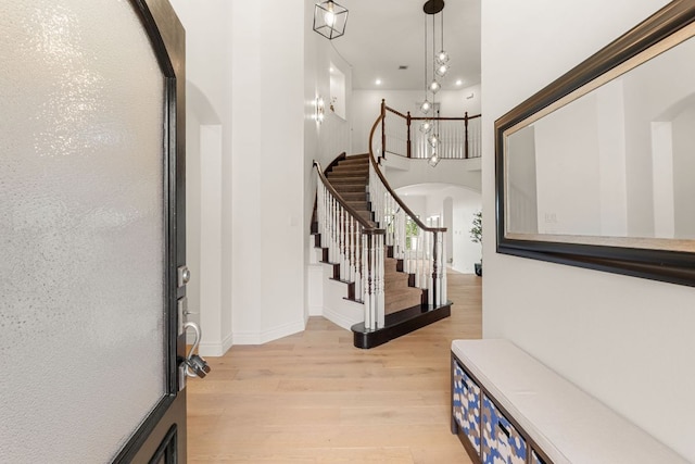 9604 Big View Dr, Austin, TX 78730 - entryway featuring light wood-style floors, arched walkways, and stairs