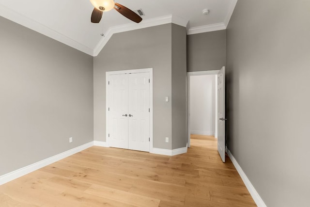 9604 Big View Dr, Austin, TX 78730 - unfurnished bedroom featuring crown molding, light wood-type flooring, a closet, lofted ceiling, and ceiling fan