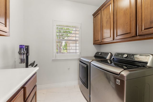 9604 Big View Dr, Austin, TX 78730 - laundry area featuring cabinet space, washing machine and dryer, and light marble finish floors