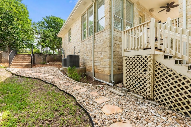 9604 Big View Dr, Austin, TX 78730 - view of side of property featuring stairway, a ceiling fan, and stone siding