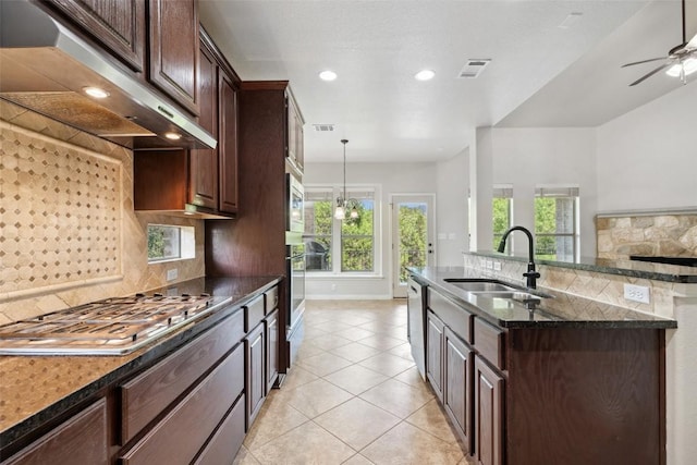 21816 Agarito Ln, Spicewood, TX 78669 - kitchen with a sink, under cabinet range hood, tasteful backsplash, light tile patterned flooring, and stainless steel appliances