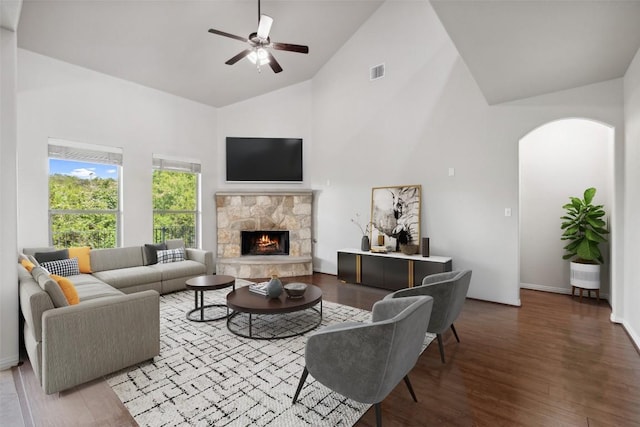 21816 Agarito Ln, Spicewood, TX 78669 - living area with high vaulted ceiling, ceiling fan, wood finished floors, a stone fireplace, and arched walkways