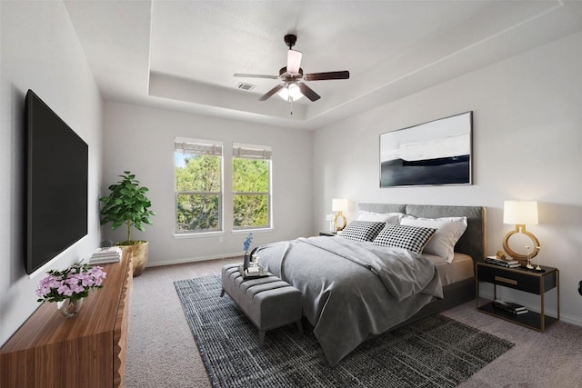 21816 Agarito Ln, Spicewood, TX 78669 - carpeted bedroom featuring baseboards, a tray ceiling, and a ceiling fan