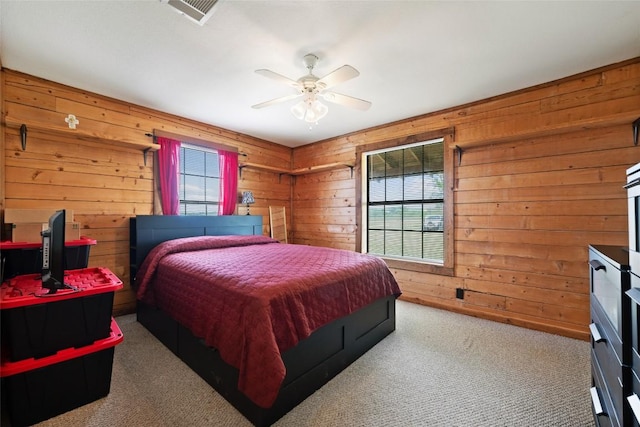 16009 Bobby Rd, Manor, TX 78653 - bedroom with carpet floors, wood walls, and a ceiling fan