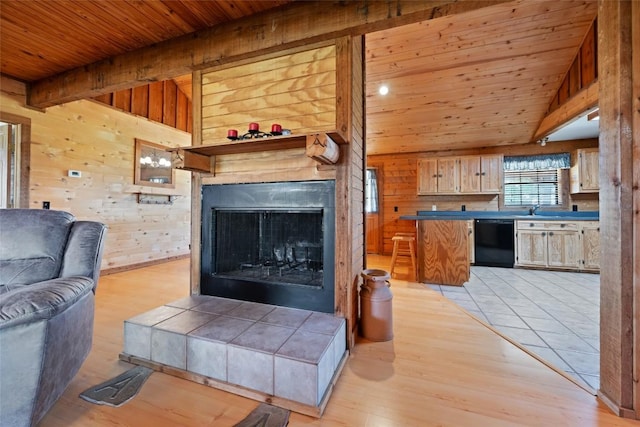 16009 Bobby Rd, Manor, TX 78653 - living room with wooden ceiling, wooden walls, light wood-style flooring, and a fireplace