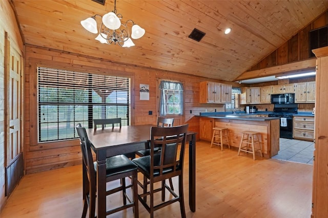 16009 Bobby Rd, Manor, TX 78653 - dining space featuring wooden walls, wood ceiling, a chandelier, light wood-style floors, and high vaulted ceiling