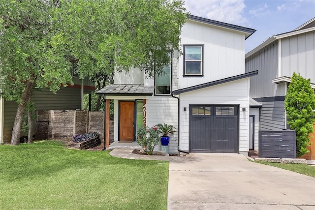 4612 Windy Brook Dr Unit A, Austin, TX 78723 - view of front facade with driveway, an attached garage, a standing seam roof, and metal roof