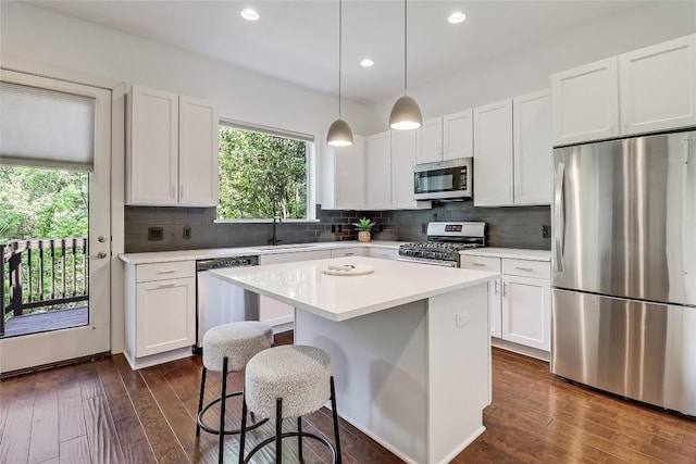 4612 Windy Brook Dr Unit A, Austin, TX 78723 - kitchen with stainless steel appliances, a sink, white cabinetry, dark wood-style flooring, and light countertops
