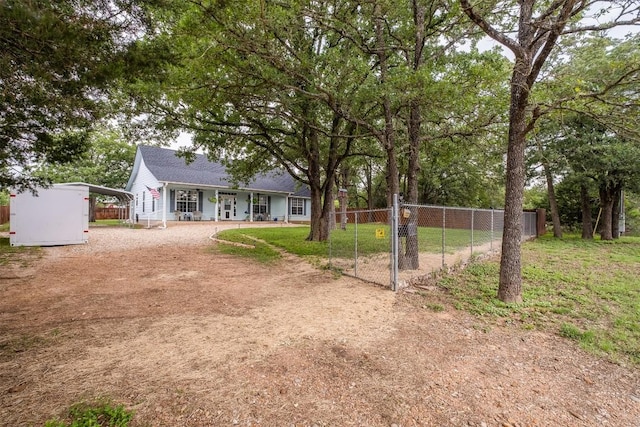 146 Long Shadow Dr, Bastrop, TX 78602 - view of yard featuring dirt driveway, fence, a carport, and a porch