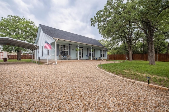 146 Long Shadow Dr, Bastrop, TX 78602 - back of property featuring a detached carport, covered porch, and a shingled roof