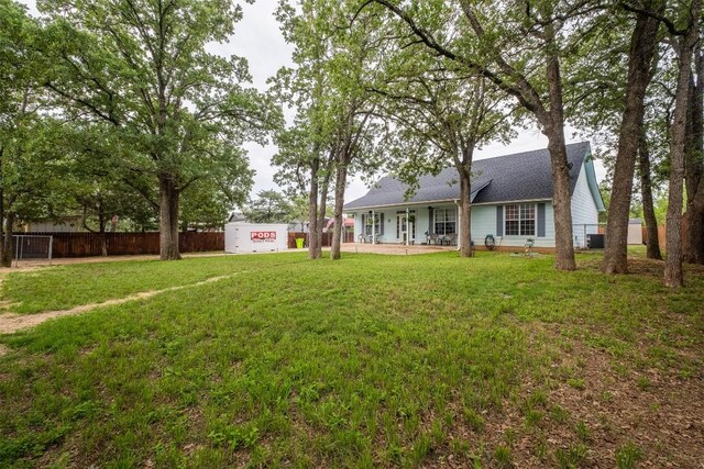 146 Long Shadow Dr, Bastrop, TX 78602 - rear view of property featuring covered porch, central AC, and a shingled roof
